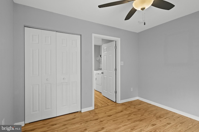 unfurnished bedroom with light wood-type flooring, washer and dryer, ceiling fan, and a closet