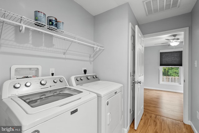 laundry room with washer and clothes dryer, ceiling fan, and light hardwood / wood-style flooring