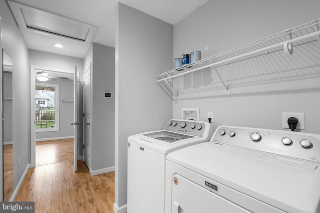 washroom with light hardwood / wood-style flooring, ceiling fan, and washing machine and clothes dryer