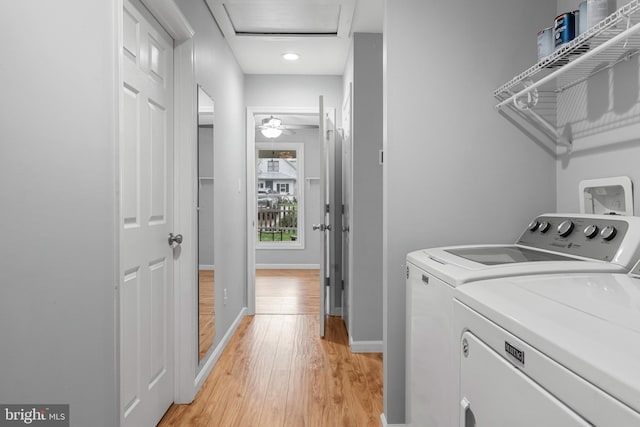 washroom featuring light hardwood / wood-style floors and washing machine and clothes dryer