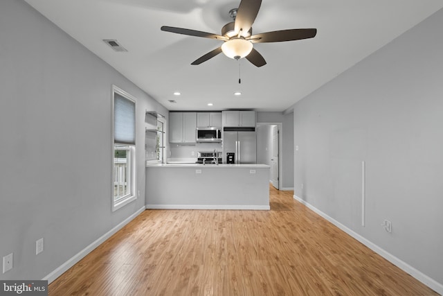 unfurnished living room with light hardwood / wood-style flooring and ceiling fan