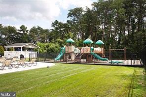 community jungle gym featuring a lawn