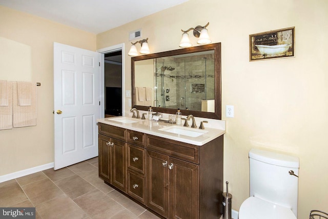 bathroom featuring tile patterned flooring, walk in shower, vanity, and toilet