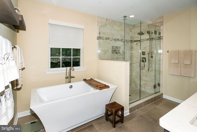 bathroom with plus walk in shower and tile patterned flooring