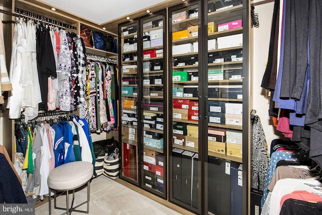 walk in closet featuring light carpet