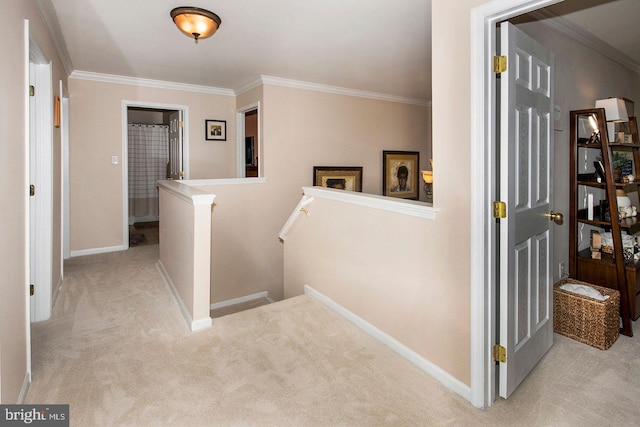 hall with ornamental molding and light colored carpet