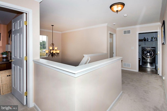 hallway featuring crown molding, a chandelier, and light colored carpet