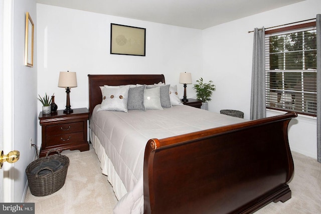 bedroom featuring light carpet