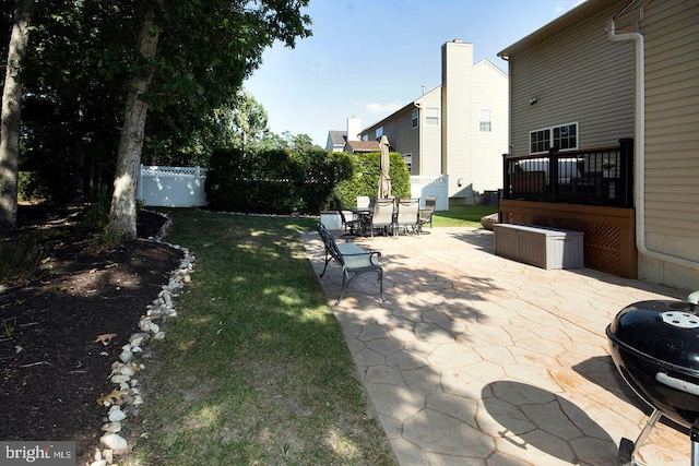 view of yard with outdoor dining space, a patio area, and fence