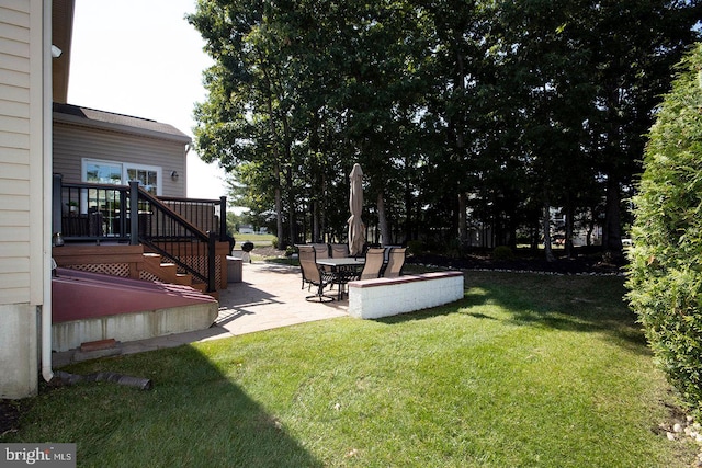 view of yard with a wooden deck and a patio area