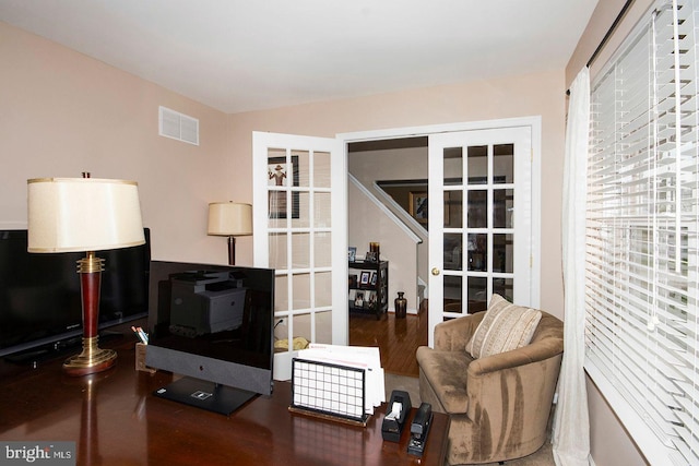 office with visible vents, wood finished floors, and french doors