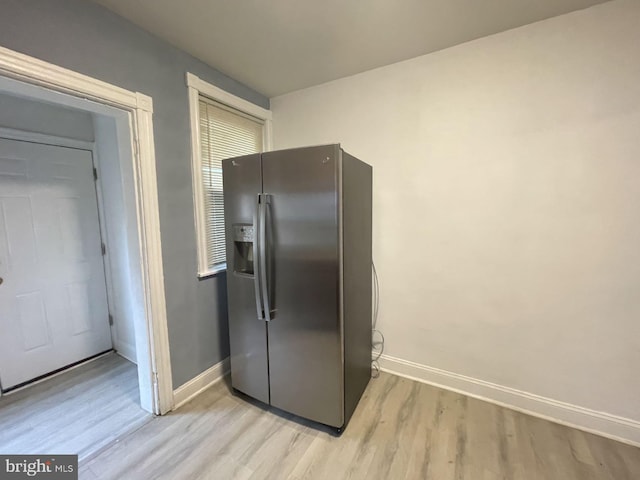 kitchen featuring stainless steel fridge with ice dispenser and light hardwood / wood-style floors