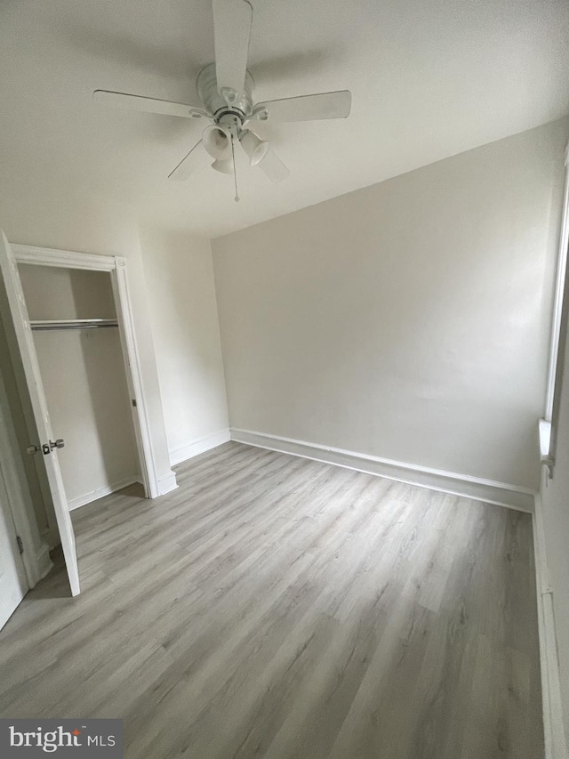 unfurnished bedroom featuring hardwood / wood-style floors and ceiling fan