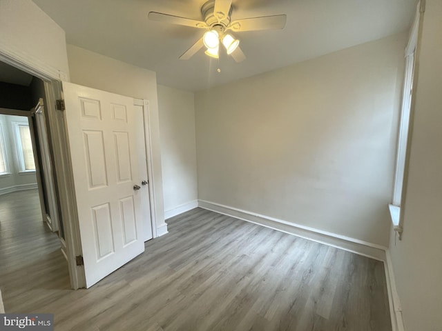 unfurnished bedroom with ceiling fan and hardwood / wood-style flooring