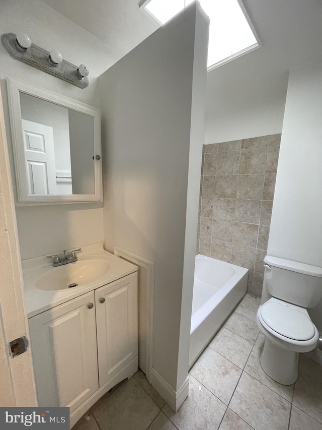 bathroom with a tub, tile patterned floors, toilet, and vanity