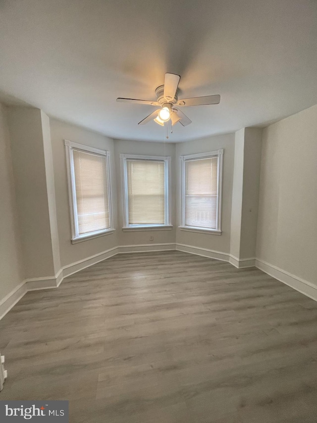 unfurnished room featuring ceiling fan and hardwood / wood-style flooring