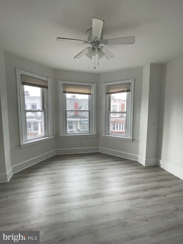 spare room featuring hardwood / wood-style floors and ceiling fan