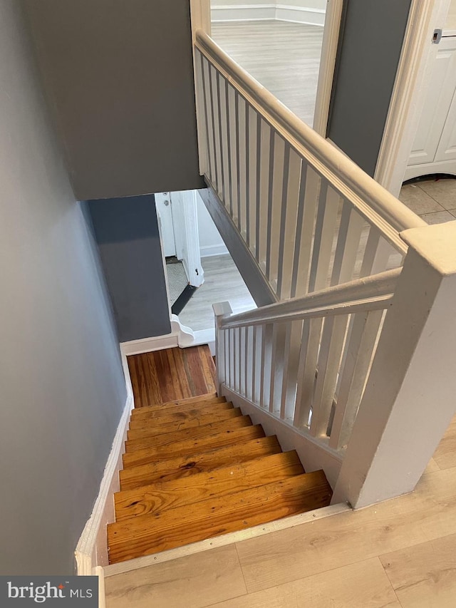 stairway featuring wood-type flooring