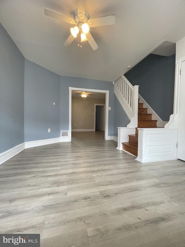 unfurnished living room with hardwood / wood-style flooring and ceiling fan