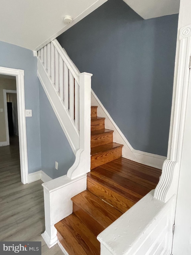 staircase with wood-type flooring