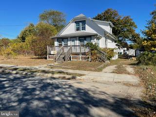 bungalow-style home with a front yard and a deck