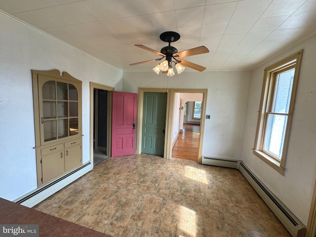 empty room with ceiling fan, hardwood / wood-style flooring, and baseboard heating