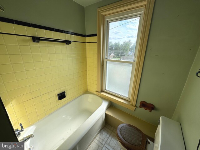 empty room with ornamental molding, ceiling fan, baseboard heating, and dark wood-type flooring