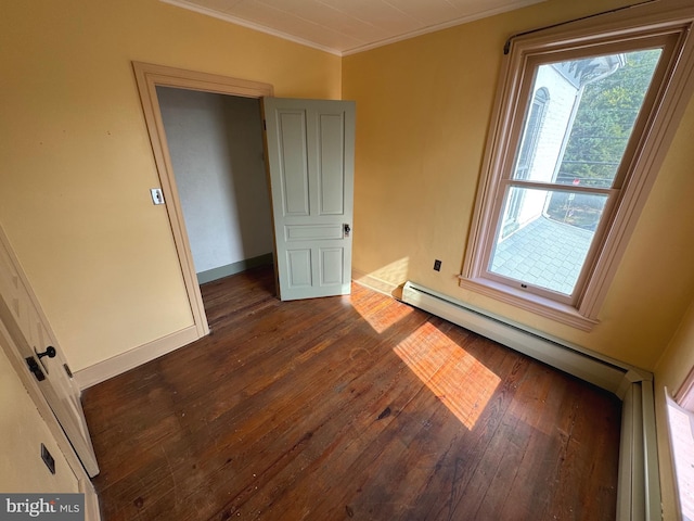 empty room featuring crown molding and dark hardwood / wood-style flooring