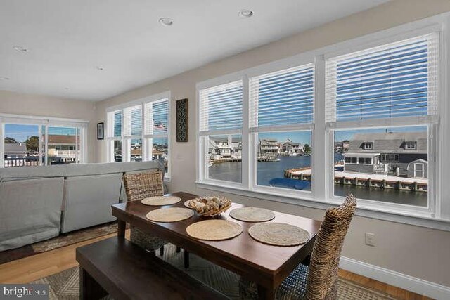 dining area featuring beverage cooler and light hardwood / wood-style floors