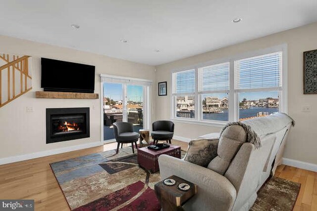 dining room featuring wood-type flooring and a water view