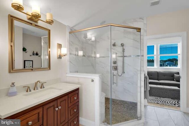 bathroom with toilet, a shower with door, and vanity