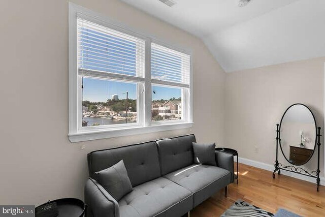 sitting room with vaulted ceiling and light hardwood / wood-style floors