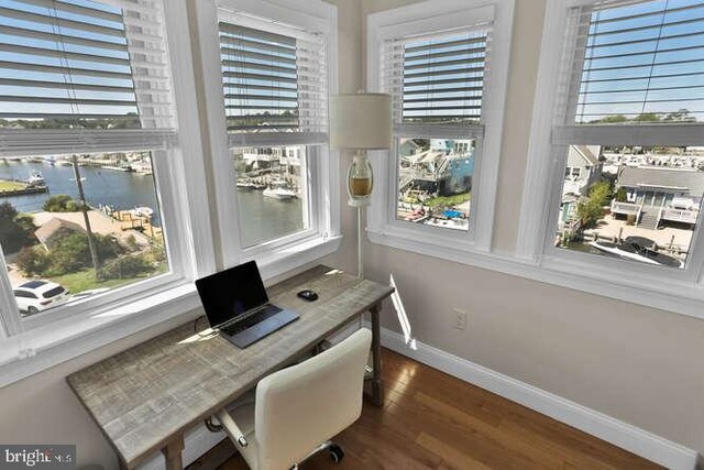 home office with plenty of natural light and wood-type flooring