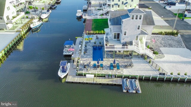 view of swimming pool with a water view and a patio area