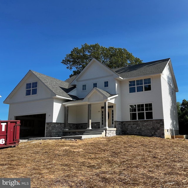 view of front facade with a garage and covered porch