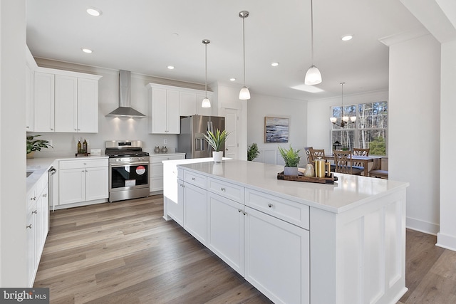 1333 German Driveway, Hanover, MD 21076 - kitchen featuring stainless steel appliances, wall chimney range hood, a chandelier, light wood-style floors, and a center island