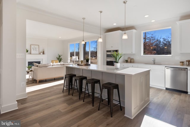 1333 German Driveway, Hanover, MD 21076 - kitchen with appliances with stainless steel finishes, white cabinets, a kitchen island, wood finished floors, and recessed lighting