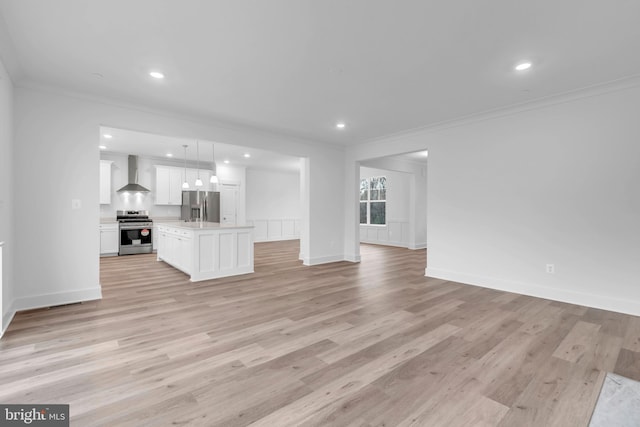 unfurnished living room with recessed lighting, ornamental molding, and light wood finished floors