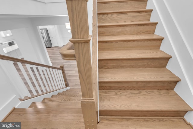 stairs with wood-type flooring