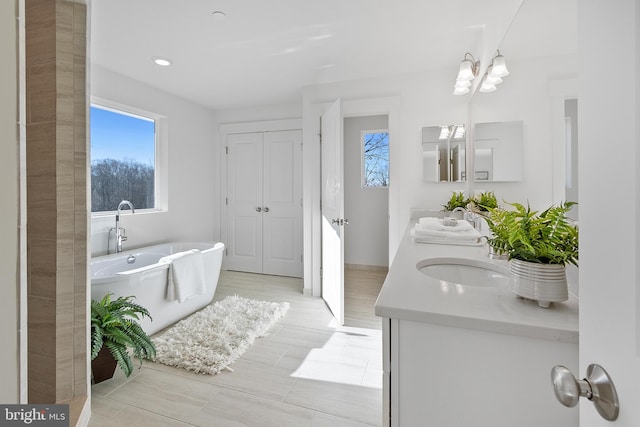 1333 German Driveway, Hanover, MD 21076 - bathroom with double vanity, healthy amount of natural light, a soaking tub, and recessed lighting