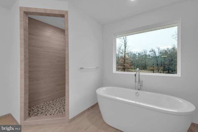 bathroom with tile patterned floors and separate shower and tub