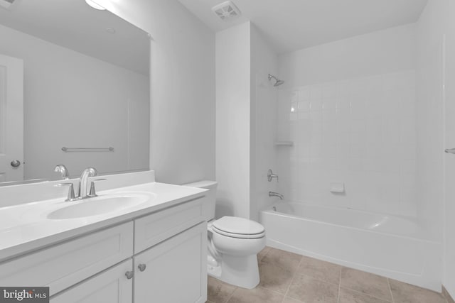 full bathroom featuring tile patterned floors, vanity, tiled shower / bath combo, and toilet