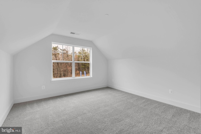 bonus room featuring carpet flooring and vaulted ceiling