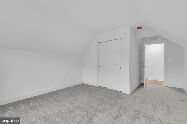 bonus room with lofted ceiling, baseboards, visible vents, and carpet floors