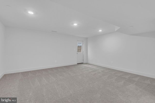 unfurnished room featuring recessed lighting, baseboards, and light colored carpet