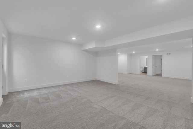 finished basement with recessed lighting, visible vents, light carpet, and baseboards