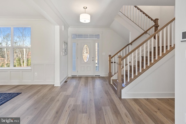 1333 German Driveway, Hanover, MD 21076 - foyer entrance with stairway, wood finished floors, crown molding, and wainscoting