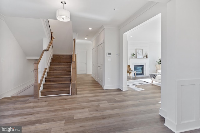 1333 German Driveway, Hanover, MD 21076 - staircase with wood finished floors, a glass covered fireplace, recessed lighting, and ornamental molding