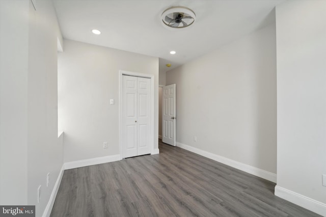 interior space with ceiling fan and dark hardwood / wood-style floors