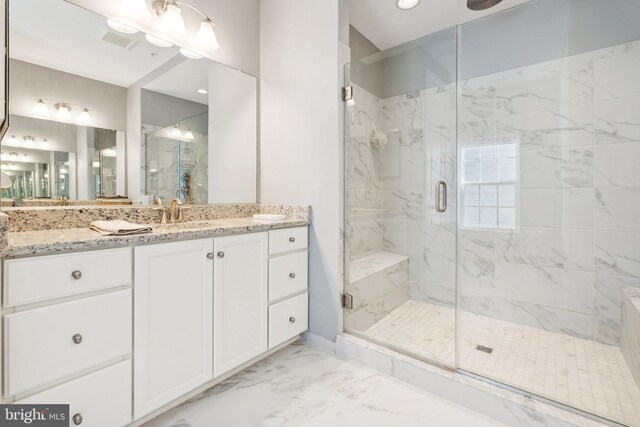 full bathroom featuring vanity, visible vents, marble finish floor, and a marble finish shower